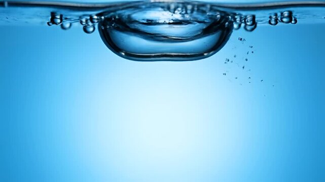 Close up of water bubbles rising to the surface in clear blue liquid.