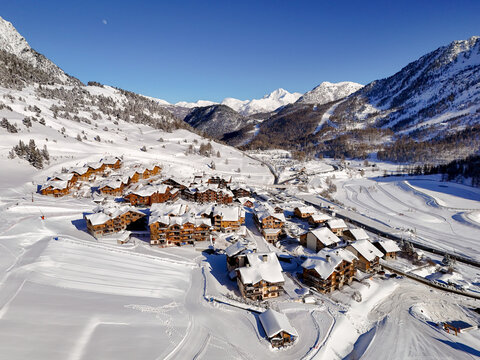 Aerial view of the snow-covered wooden chalets and ski slopes of the resort nestled in the French Alps in Montgenevre, Provence-Alpes-Cote d, France.