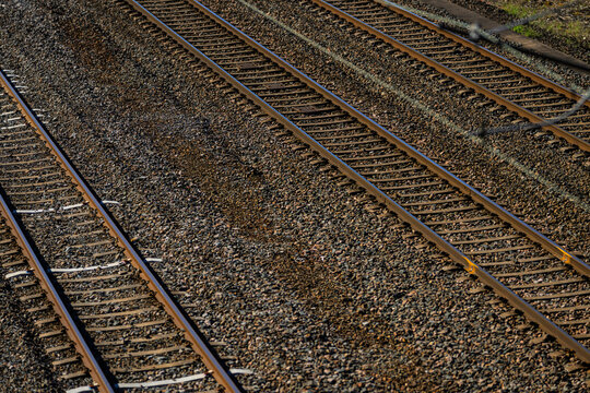 Multiple parallel railway tracks extending across gravel rail yard infrastructure.