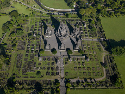Aerial view of Prambanan Temple complex with its towering stone spires and surrounding ancient ruins set amidst lush green lawns Kecamatan Prambanan, Daerah Istimewa Yogya, Indonesia.