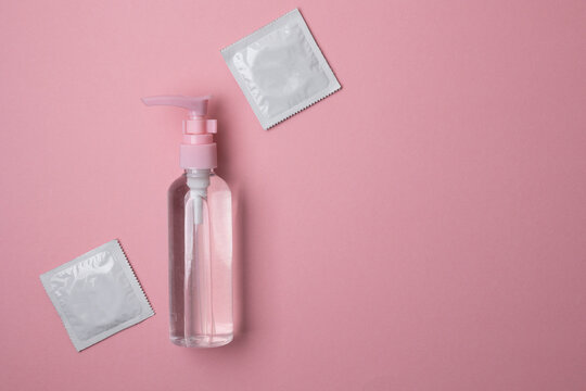 Intimate lubricant and sex toys on a colored background