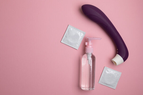Intimate lubricant and sex toys on a colored background