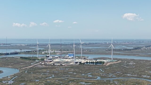Drone aerial push-in view of wind turbine electricity farm
