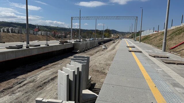 Construction of railway line LK104 with advanced ground stabilization and engineering structures. Geotechnical works including pile walls, soil reinforcement, ground nails, and slope protection system