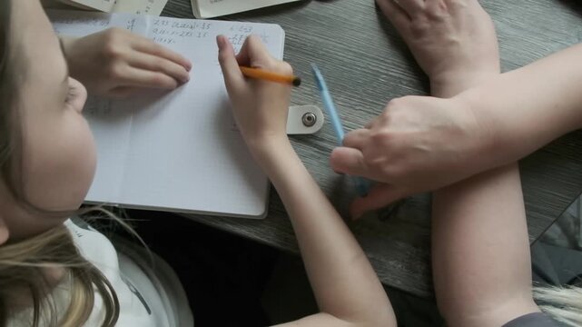 A girl studying online. Homeschooling. Remote lessons with a tutor. The child is doing homework
