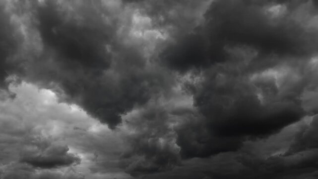 dark dramatic sky with black stormy clouds before rain as abstract background, extreme weather timelapse
