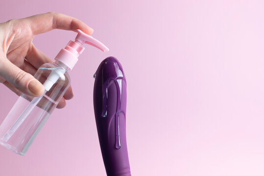 Sex toy with intimate lubricant on a colored background