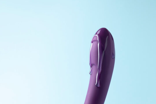 Sex toy with intimate lubricant on a colored background