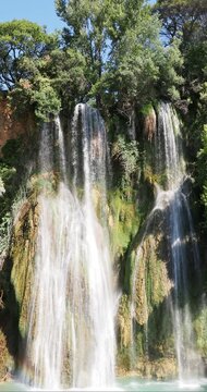 Sillans-La-Cascade. In the Proven&ccedil;al forest, at the end of the Belvedere path, rises a high cliff from which the waters of La Bresque cascade into a turquoise lagoon
