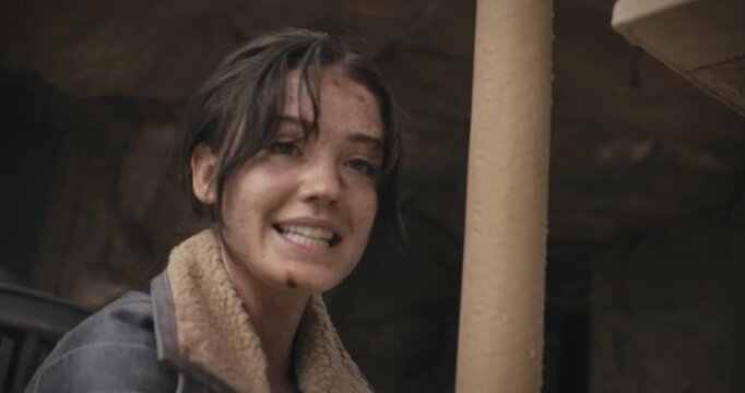 Beat up, snarky woman in sci-fi area talking to someone and escaping cuffs