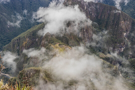 Cloudy view of Machu Picchu ruins and Urubamba river valley from Machu Picchu mountain, Peru