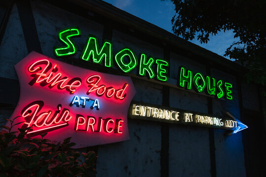 Entrance to Smoke House Restaurant featuring neon sign, famous 1946 landmark in Burbank, California, August 2020