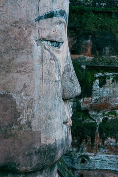 Close-up profile of the massive stone face of the ancient Leshan Giant Buddha carved into a cliff