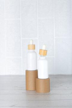 White jars containing CBD against a white background