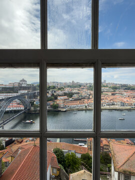 View of Porto&rsquo;s Douro River and Dom Lu&iacute;s I Bridge Through a Window