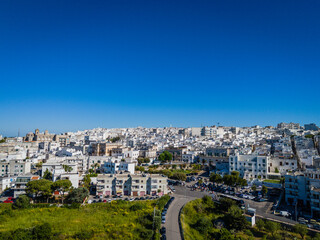 Obraz premium Ostuni, the White City of Puglia. Aerial drone view of panorama of historic Italian architecture and Mediterranean landscape. Whitewashed old town