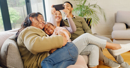Obraz premium Happy family, laughing and home with child on sofa for fun childhood, love or care together. Mom, dad and grandma with smile, kid or granddaughter for weekend, holiday or bonding on couch in house
