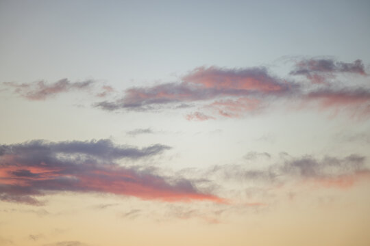 View of soft pink and purple clouds scattered across the twilight sky over Shichirigahama Beach in Kamakura, Kanagawa, Japan.