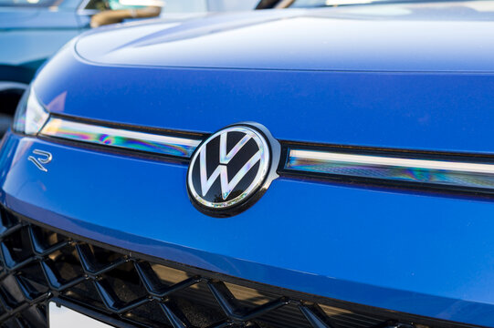 Wolfsburg, Germany, 21 May 2026: Close up of Volkswagen emblem and R badge on blue metallic car hood