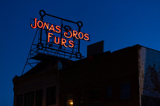 Jonas Bros Furs rooftop neon sign at dusk. Denver, Colorado, May 2019