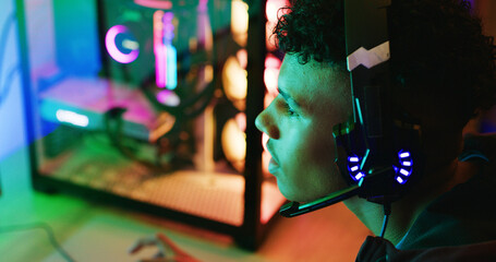 Headphones, teen and profile for gaming in home, entertainment and esports with RGB light. Headset, boy and gamer play on online competition, action and contest with gameplay audio on computer © peopleimages.com