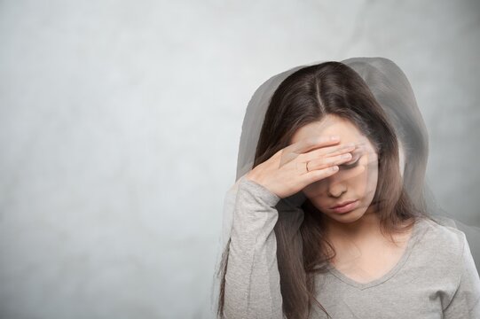 Sad woman suffering from pain feeling dizzy