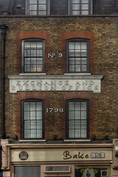 LONDON, UK - MARCH 12, 2022:  The front facade of Georgian building with sign for the Exchange and Bullion Office in Wardour Street, Soho
