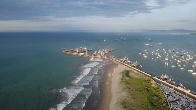 Aerial view of the port of Manta at midday when electric blue colors predominate in the Pacific Ocean of South America, Ecuador