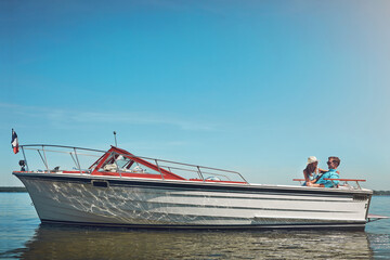 Obraz premium Love, couple and hug on boat on ocean for travel adventure, anniversary trip or bonding together. Mockup space, happy people or relax on sailing for summer getaway, romantic journey or connection