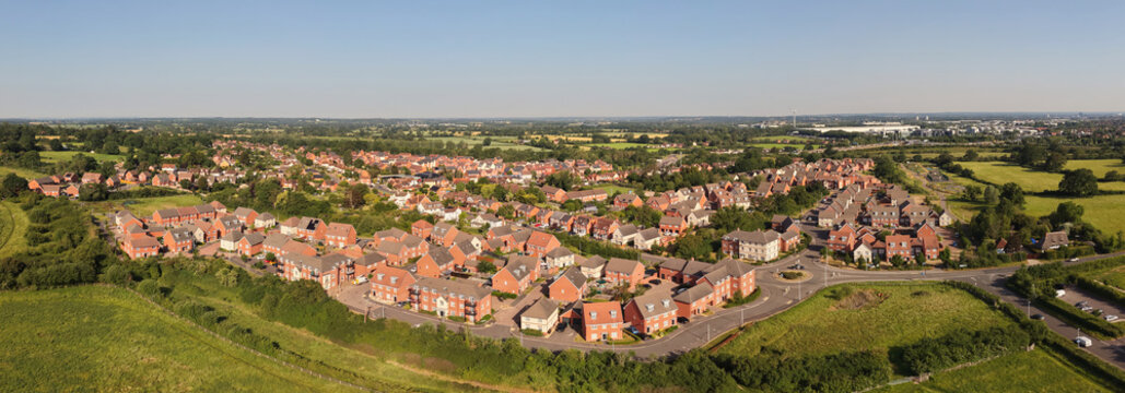 Aerial drone footage of Three Mile Cross in Berkshire, England, showcasing residential neighborhoods, surrounding countryside, and suburban development