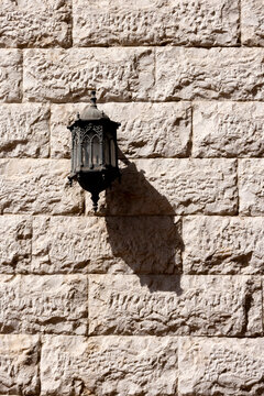 Decorative vintage street lantern on the concrete wall in Abu Dhabi, UAE