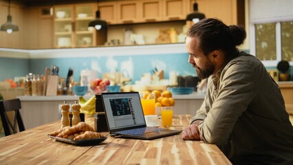 Adult man, online video content on laptop, streaming platform for digital clips, free to watch...