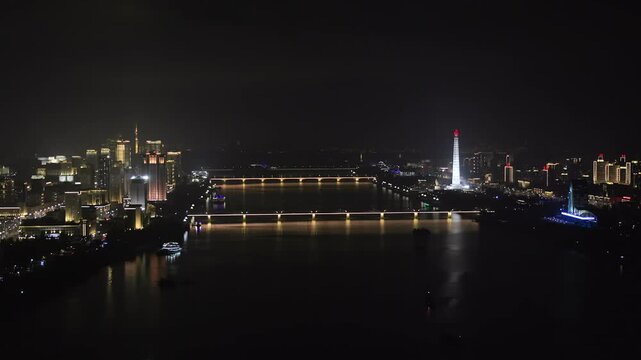 Juche Tower, Pyongyang morning panoramic view, North Korea. Taedong River in the morning fog. View facing upstream, modern residential complex. View from Yanggakdo Hotel