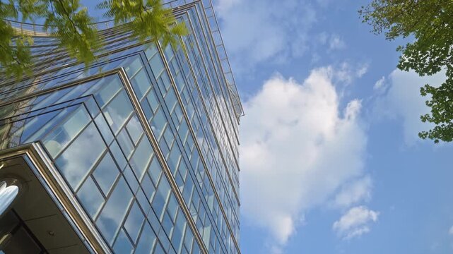 Cinematic urban scene featuring modern glass building and dynamic camera movement in corporate district, ideal for themes of business and city growth
