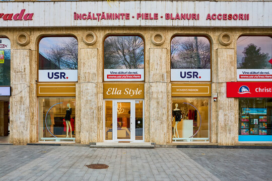 Centrally located clothing storefronts with advertisement in urban setting. March 3, 2026, Suceava Romania