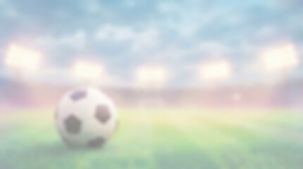 Naklejka premium Blurred Soccer Ball on Stadium Grass Field with Bright Floodlights for Sports Concept Background and Copy Space