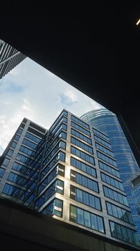Cinematic urban scene featuring modern glass buildings and dynamic camera movement in corporate district, ideal for themes of business and city growth