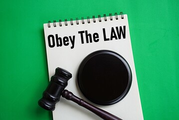 Naklejka premium Gavel and written note obey the law. Law concept. Affirmation following the rules is right. Punishment for making mistakes. Written rules