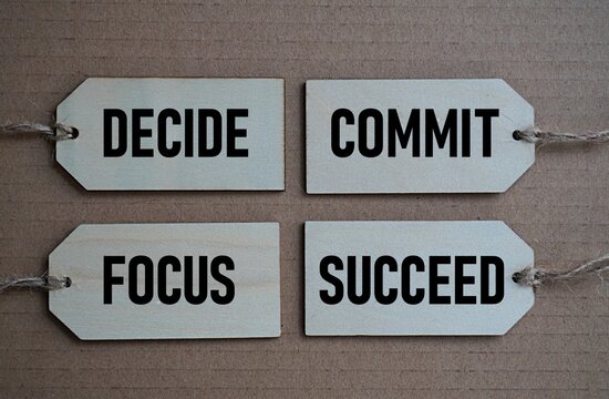 Printed wooden card decide commit focus succeed. Self-inspiration shapes personality. Self-development concept. Encouraging words. Life-changing guide