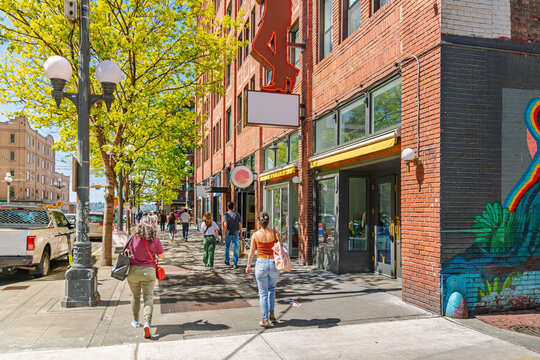 Pedestrians walk along Pine Street in downtown Seattle, Washington, just down the street from Pike Place Market on the way to the Seattle Waterfront