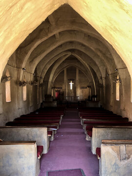 Zaria, Nigeria - 22 March 2026: View of the interior of St. Bartholomew's Church in Wusasa featuring mud-built arches, vaulted ceilings, and wooden pews leading toward the altar.