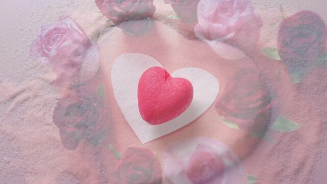Soft ripple starting rose wreath rotating as red heart staying centered, cam zooming accenting love