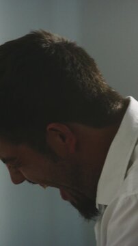 Angry, business man and crying in office for job loss, financial ruin and embezzled funds. Rage, person and emotional breakdown at work for company bankruptcy, shouting and disappointed for betrayal
