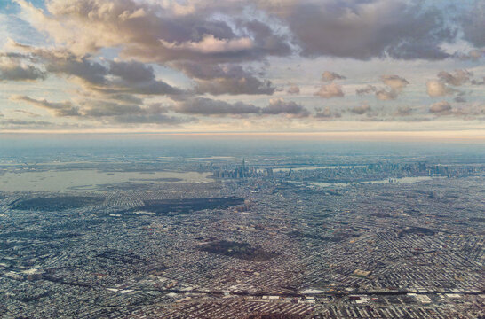 Wide Aerial View of New York City and Brooklyn Sprawl under Cloudy Skies
