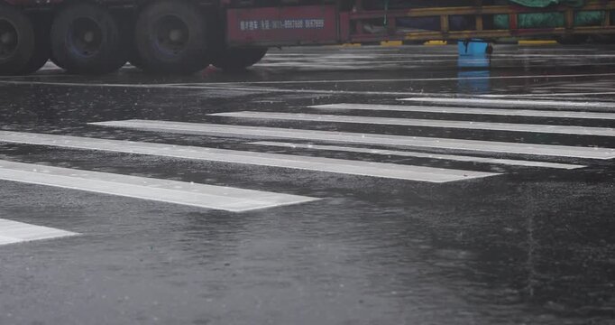 Rainy Wet Zebra Crossing with Passing Truck on Urban Road