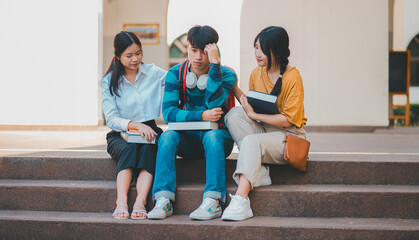 Fototapeta premium Fellow students are consoling friends who are disappointed in grades, frustrated with tasks that are not meeting their goals, helping each other.