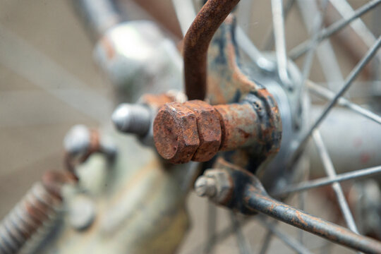 rusty bicycle wheel with nut, close up of rust on it