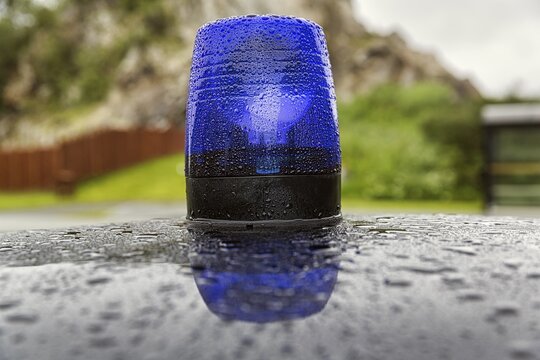 Blue light on a car roof, police patrol car, classic car, raindrops, Norway