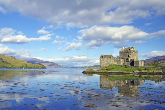 Eilean Donan Castle reflected in shallow water, Highlander, film set, Dornie, Scotland, United Kingdom