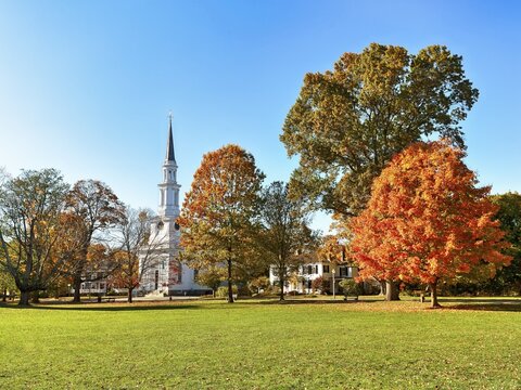 Green area with autumnal trees and church in a park, Lexington Battle Green, Lexington, Massachussets, USA